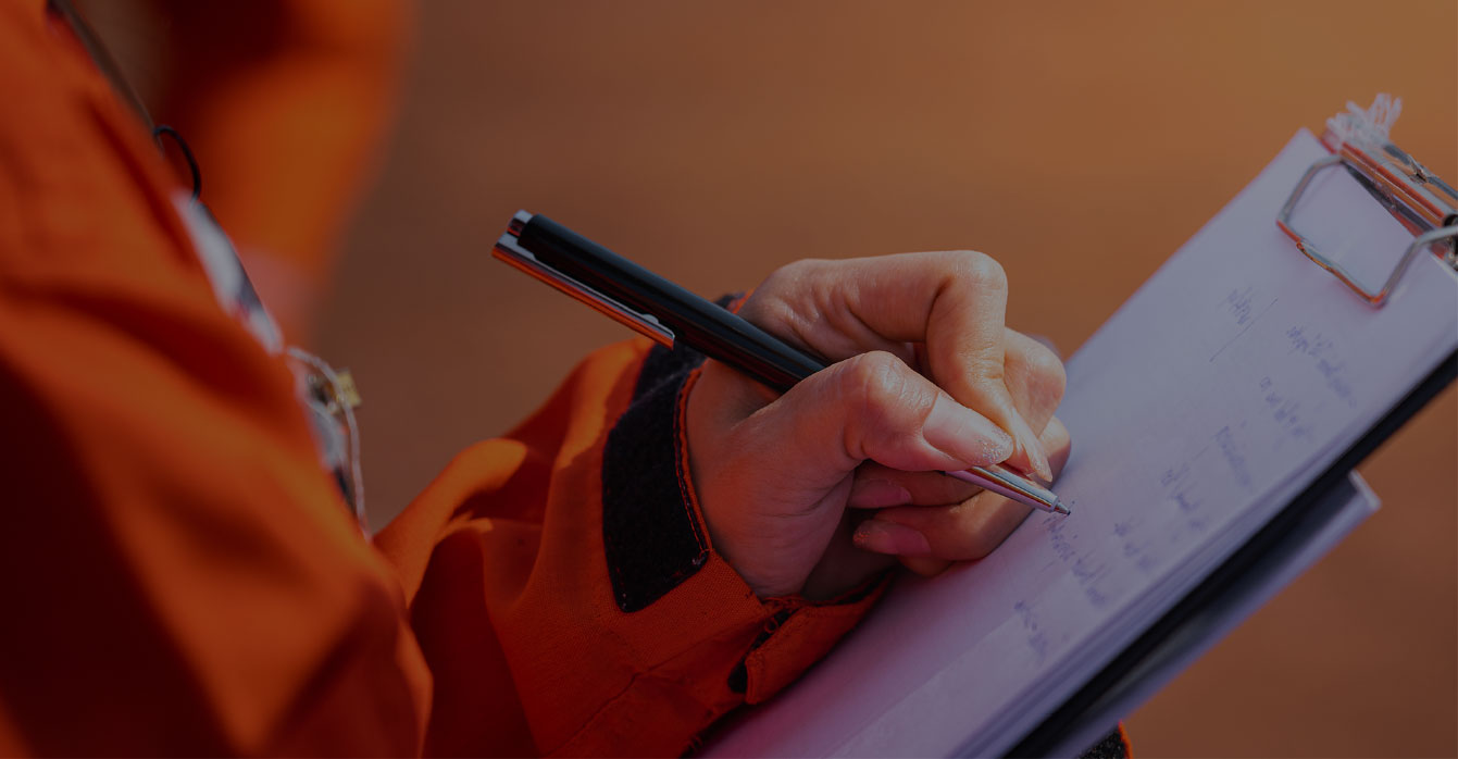 Property inspector recording observations on site